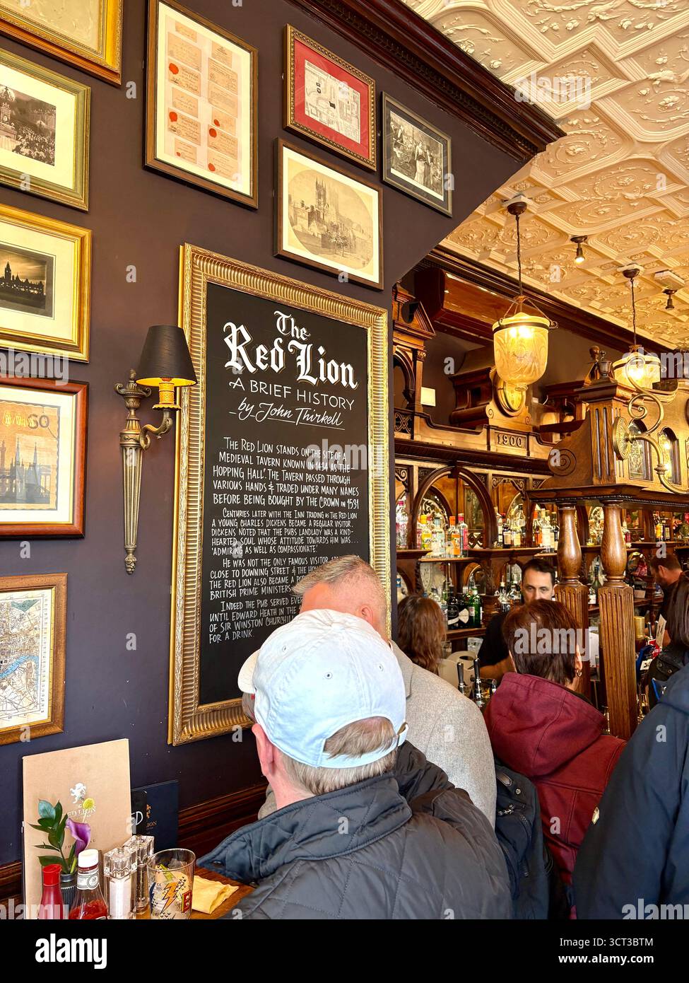 Red Lion pub London England, famous Whitehall pub near Downing Street, customers inside enjoy lunch and a pint beer drinks, UK - Smartphone Captured Stock Image