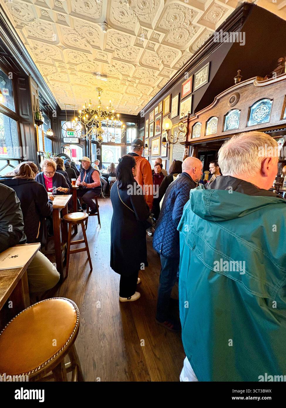 Red Lion pub London England, customers enjoying a pint and lunch inside this famous Whitehall pub, UK - Smartphone Captured Stock Image