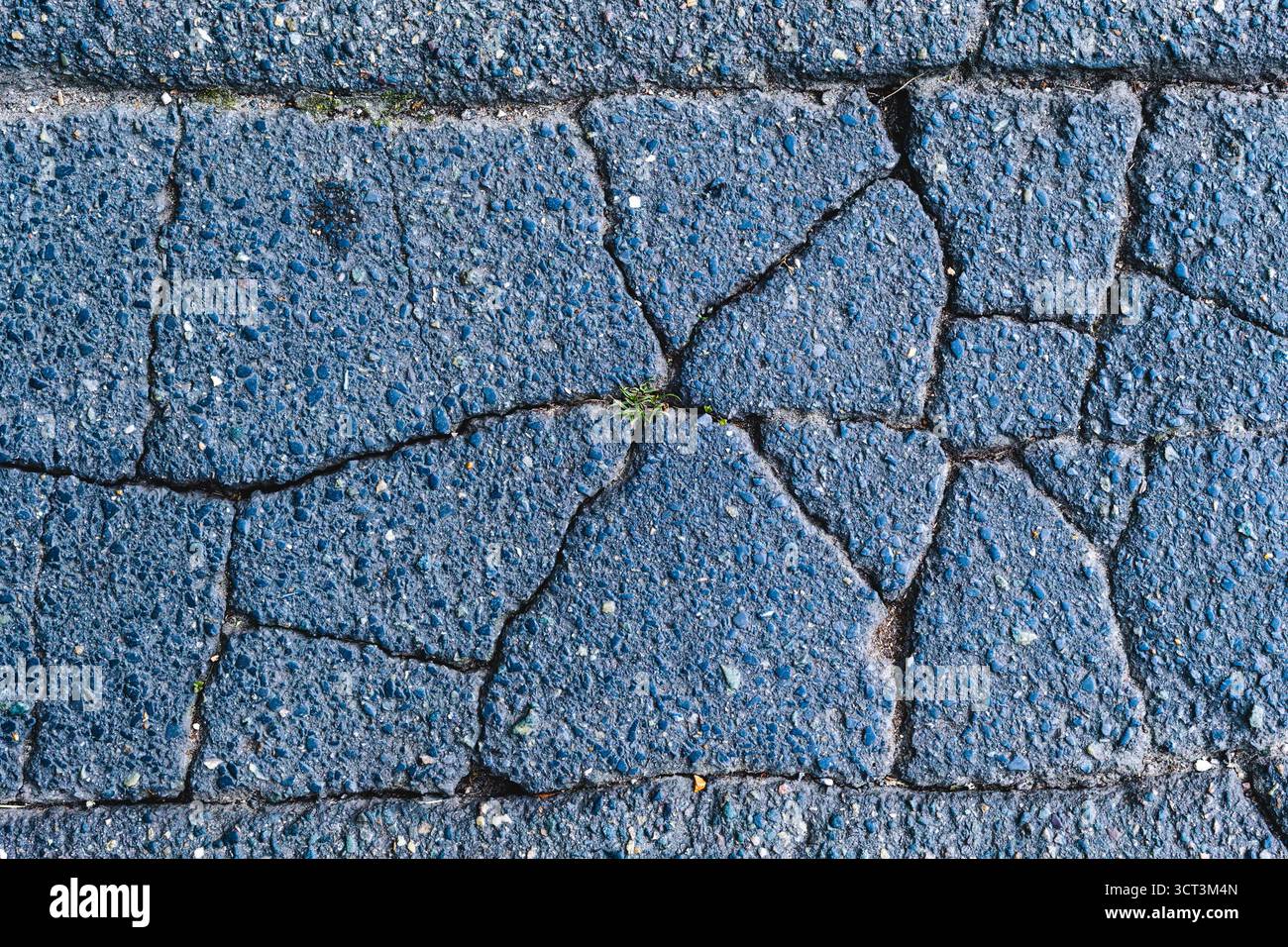 A damaged cracked paved road material Stock Photo