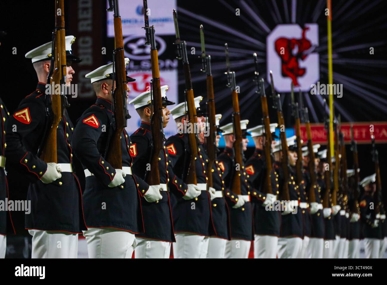 U.S. Marines with the United States Marine Corps Silent Drill Platoon execute their "long line" sequence during a half-time performance at a Gainesvil Stock Photo