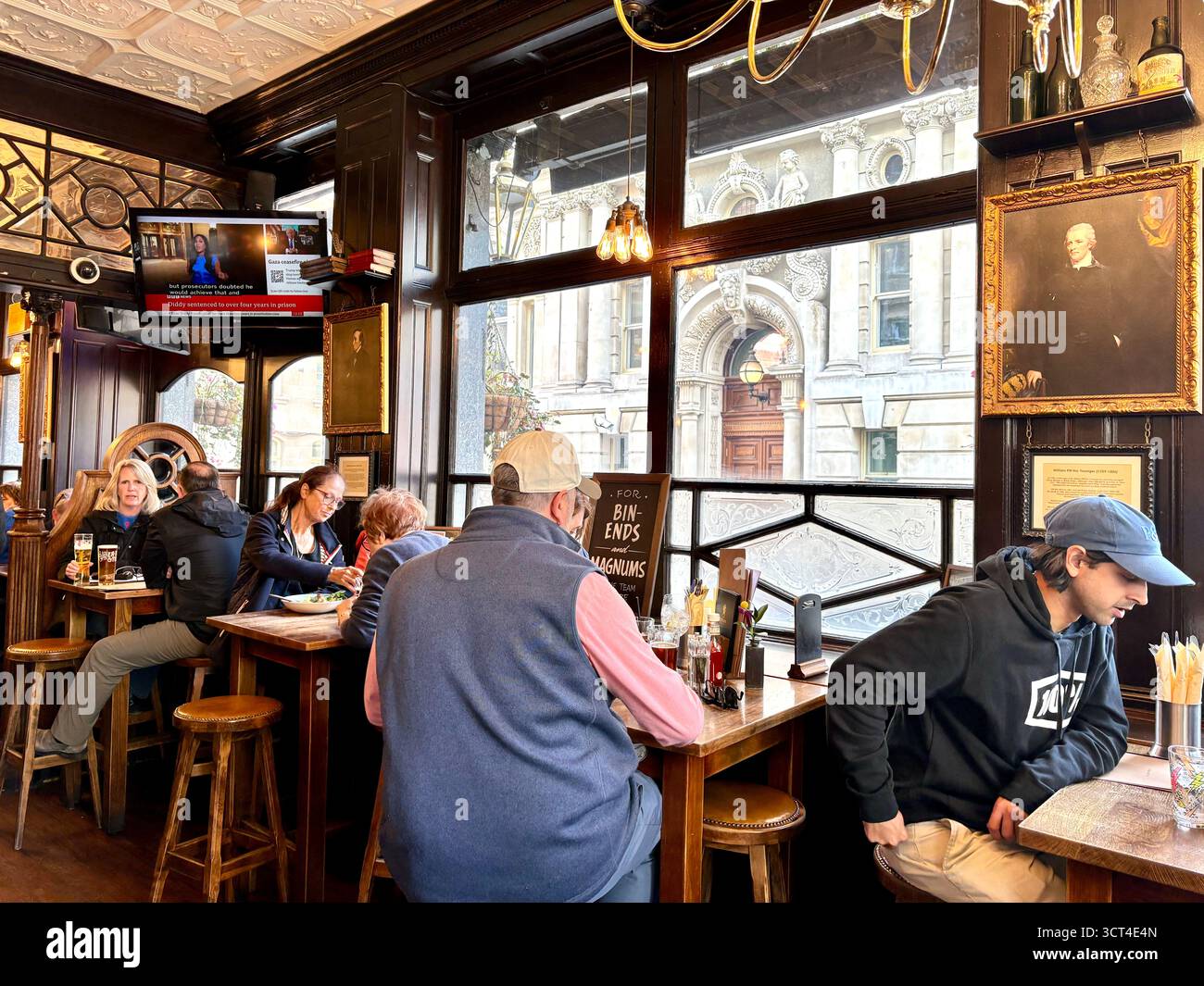 The Red Lion pub, Parliament street,Whitehall, London,England, pub interior people drinking and having lunch - Smartphone Captured Stock Image