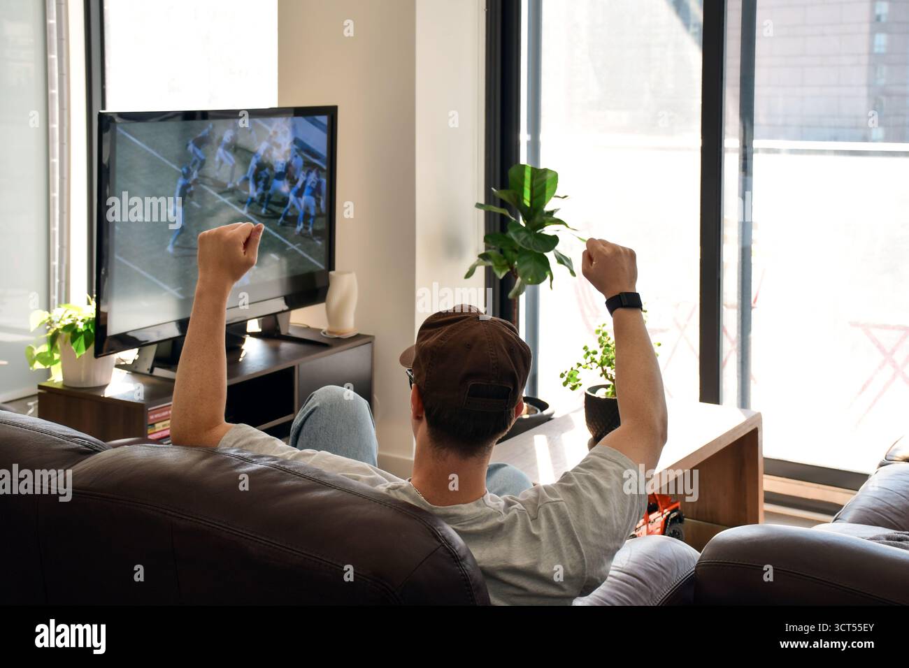 Man watching football game at home hi-res stock photography and images -  Alamy