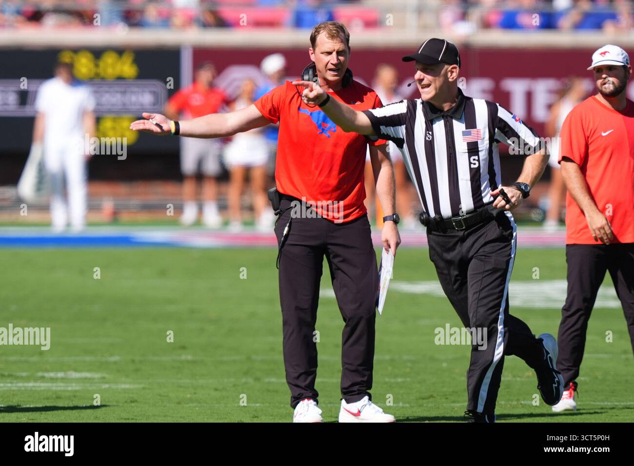 SMU head coach Rhett Lashlee, left, makes a point with an official ...