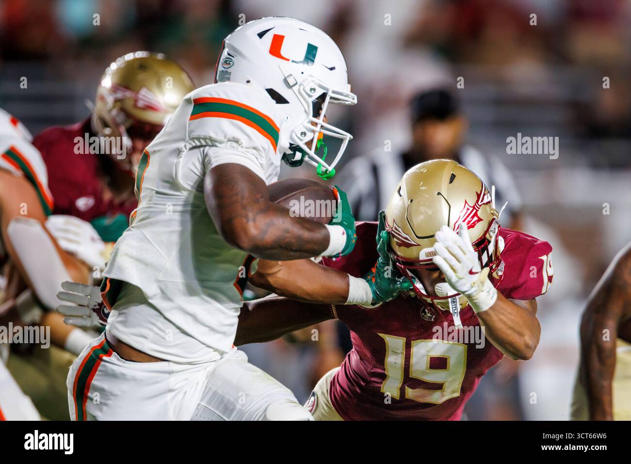 Miami running back Jordan Lyle (2) pushes away Florida State defensive ...