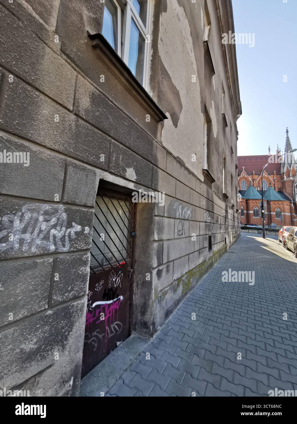 Tiny door on Ulica Rękawka, Kraków—used when main Parkowa entrance was bricked up—marks Roman Polanski’s wartime home in the Kraków Ghetto, Podgórze. - Smartphone Captured Stock Image