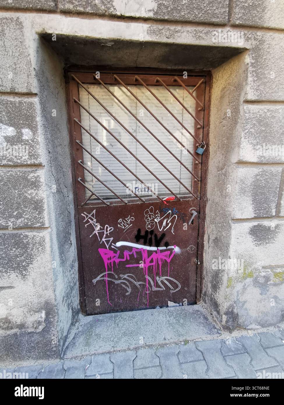 Tiny door on Ulica Rękawka, Kraków—used when main Parkowa entrance was bricked up—marks Roman Polanski’s wartime home in the Kraków Ghetto, Podgórze. - Smartphone Captured Stock Image