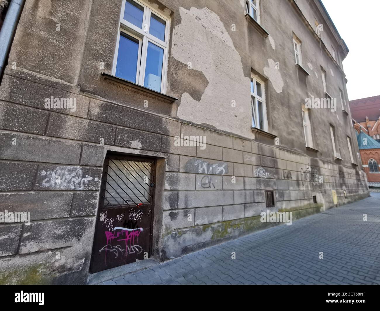 Tiny door on Ulica Rękawka, Kraków—used when main Parkowa entrance was bricked up—marks Roman Polanski’s wartime home in the Kraków Ghetto, Podgórze. - Smartphone Captured Stock Image