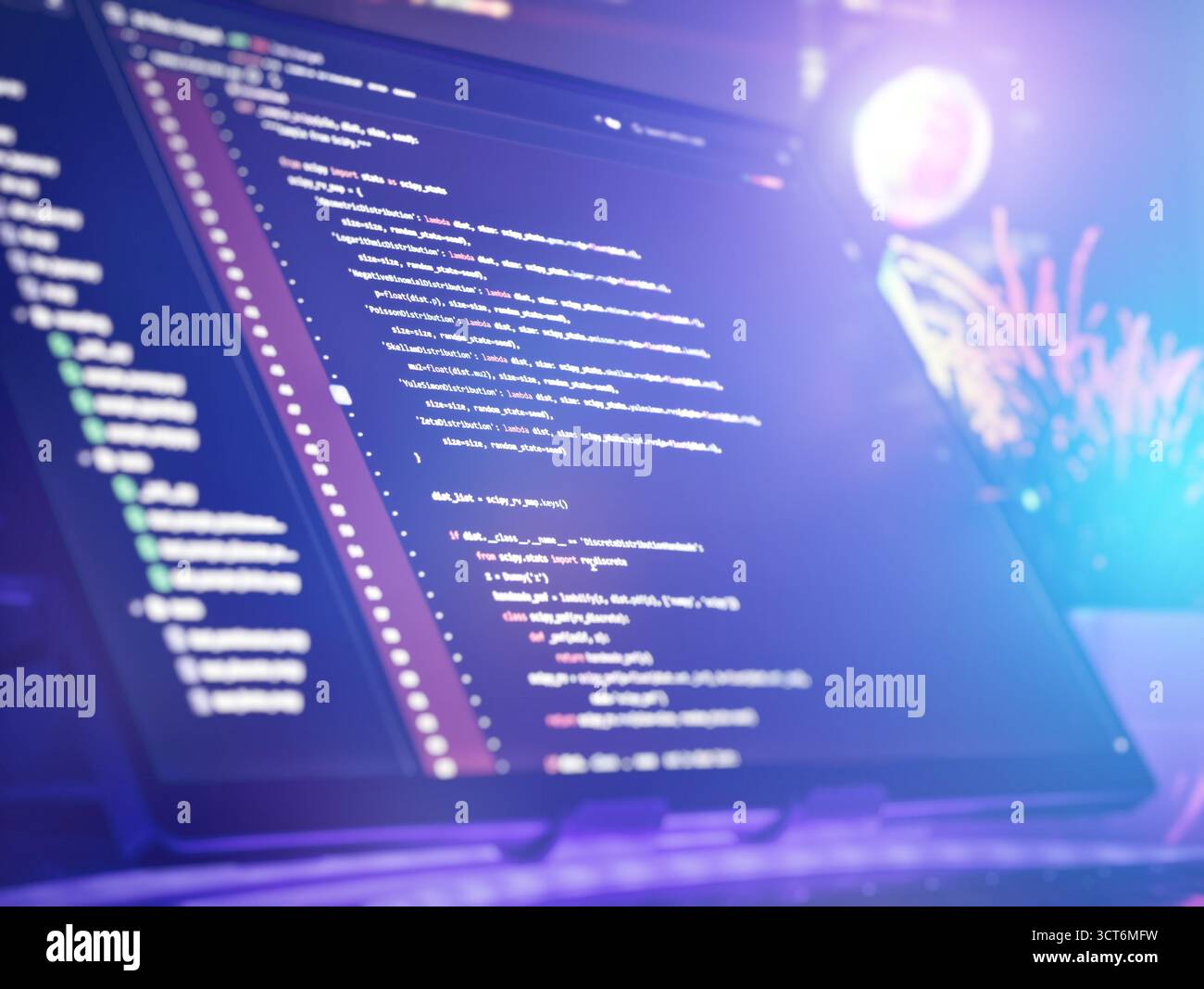 Close-up of a computer screen displaying Python code in a stylish workspace, illuminated by blue and purple ambient lighting. Stock Photo