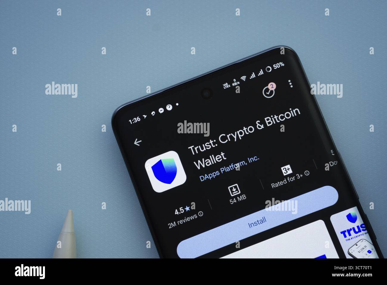 Dhaka, Bangladesh- 30 Sep 2025: On a blue surface, a smartphone displays  the Trust Wallet app within the Google Play Store Stock Photo - Alamy