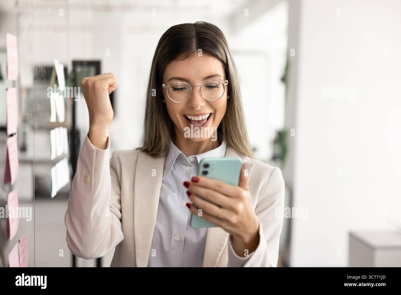 Happy successful Latin professional woman using smartphone Stock Photo