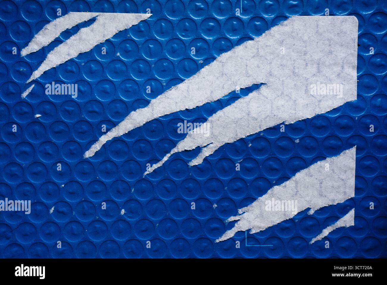 Blue bubble wrap package with aggressively peeled paper label sticker texture Stock Photo