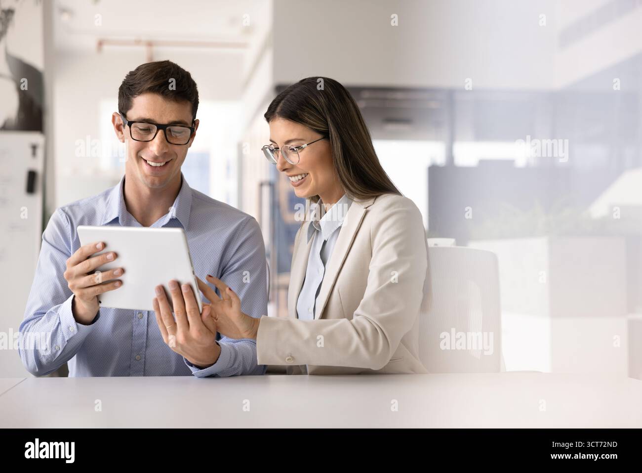 Happy young managers working on online project solution together Stock Photo