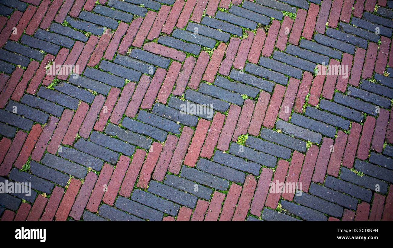 Red and black herringbone brick pavement pattern. Top-down view of ...