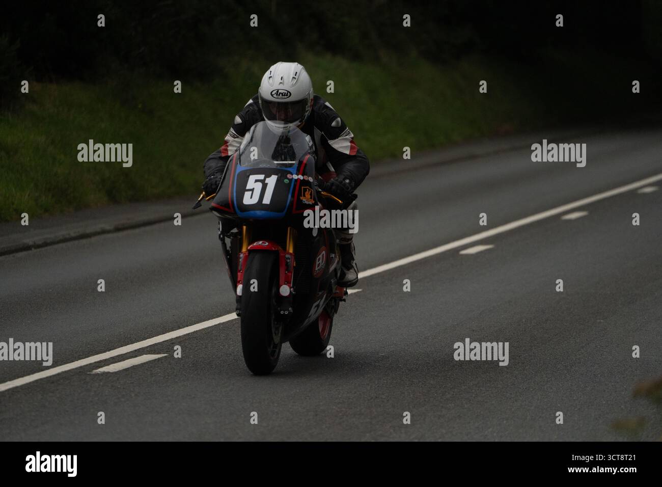 Number 51 Racing Racing motorcyclist number 51 on tarmac road circuit with white road ...