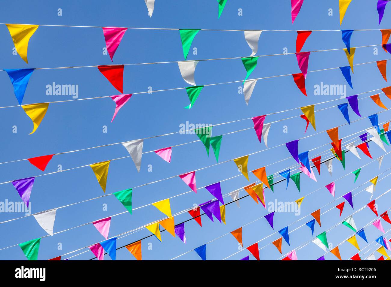 Multi colored party flags against the blue sky Stock Photo