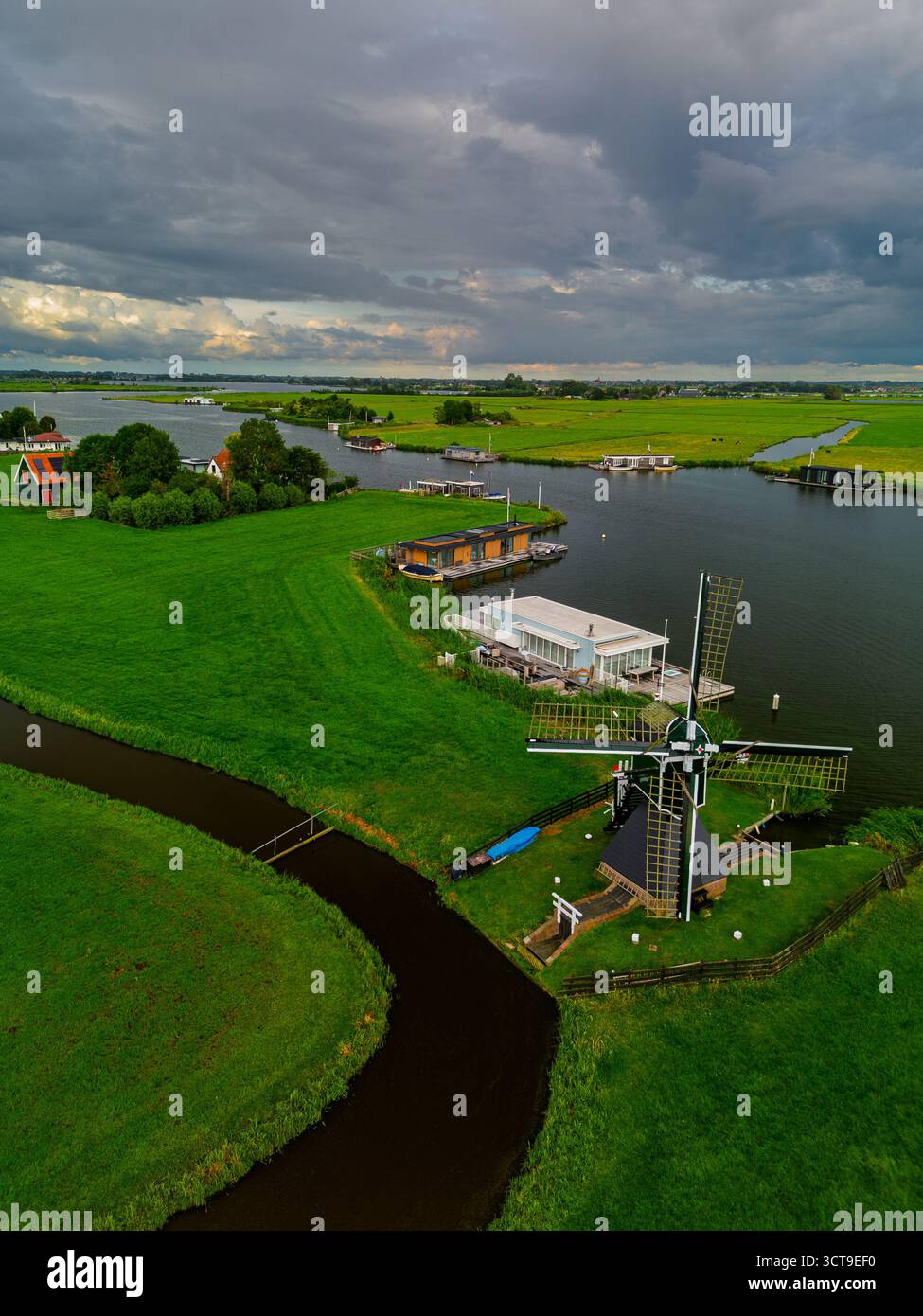 Aerial view of Dutch countryside with central windmill, houseboats ...