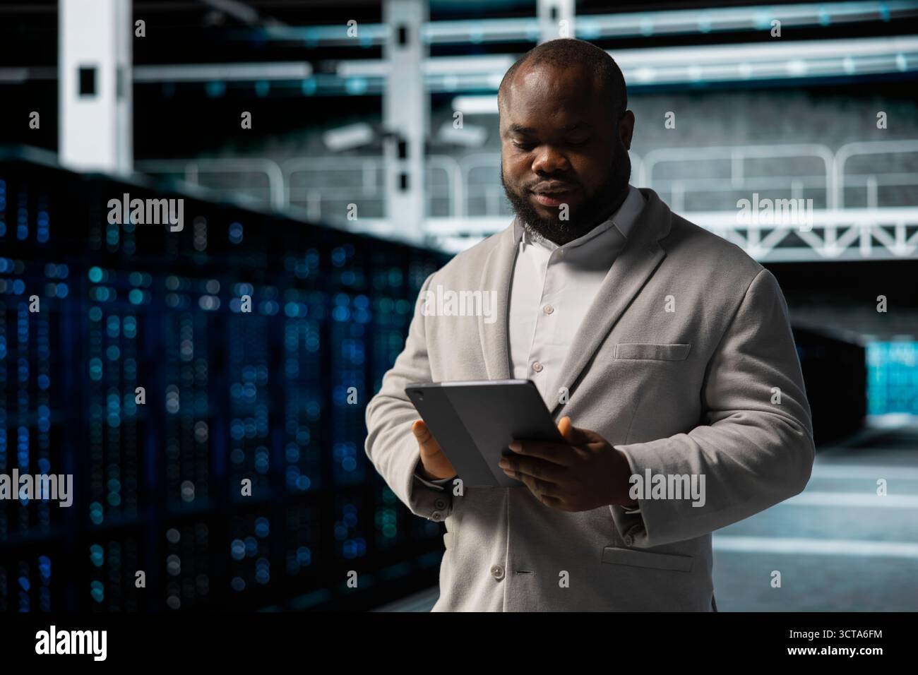 Data center employee fixing network issues affecting rigs performance, scripting automated workflows. Technician running system diagnostic tests, evaluating reports on tablet Stock Photo