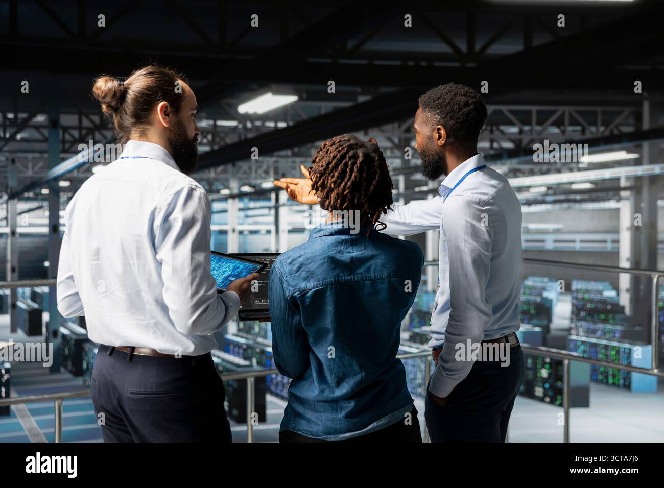 Data center staff on industrial platform collaborating to maintain servers using artificial intelligence. Engineers doing teamwork to support infrastructure AI deep learning automatization. Stock Photo