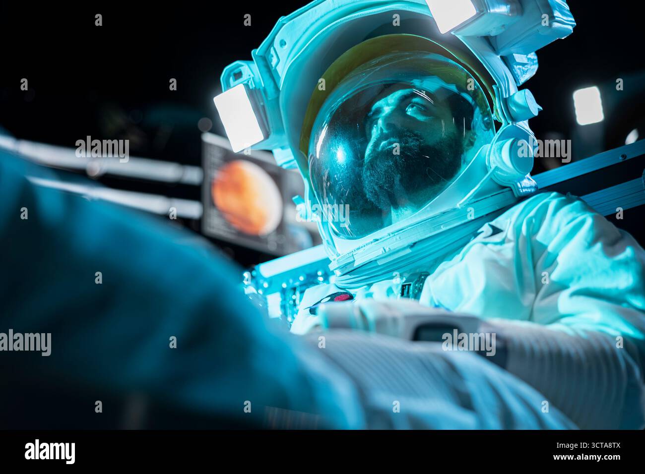 Cosmonaut losing hope, fainting after space station catastrophe during journey to Mars. Blue lights flashing over man despairing after spaceship getting damaged during red planet voyage Stock Photo