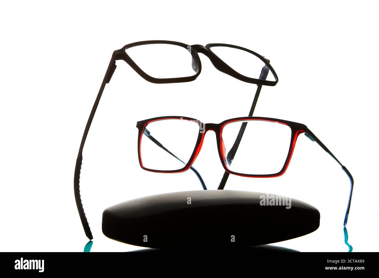 Modern eyeglasses resting on a protective case isolated on white background symbolizing optical healthcare, lifestyle, fashion accessory and professio Stock Photo