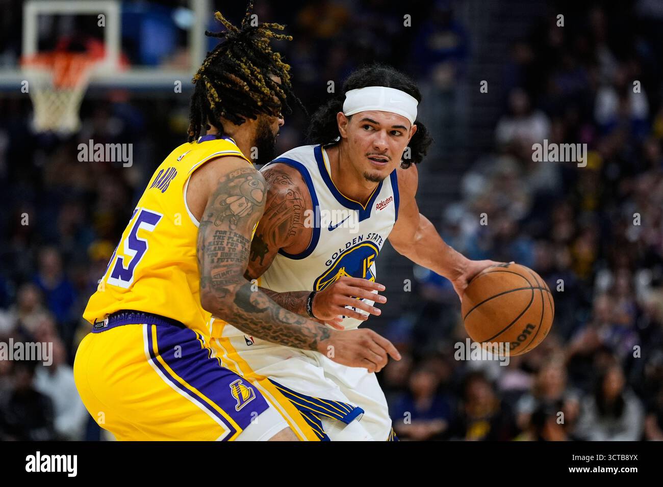 Golden State Warriors forward Gui Santos, right, moves the ball while