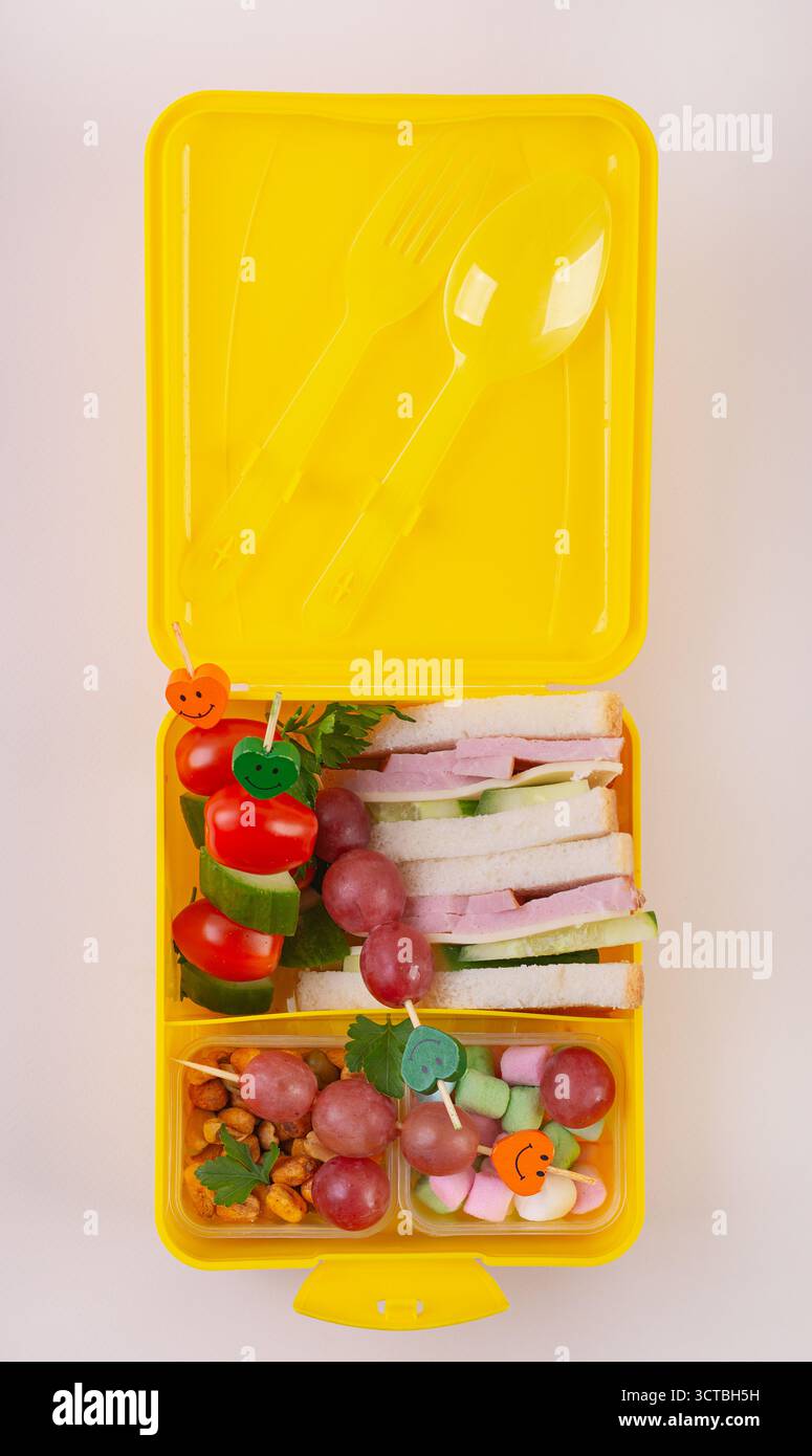 Healthy Lunchbox with Sandwich and Fruit Skewers Stock Photo