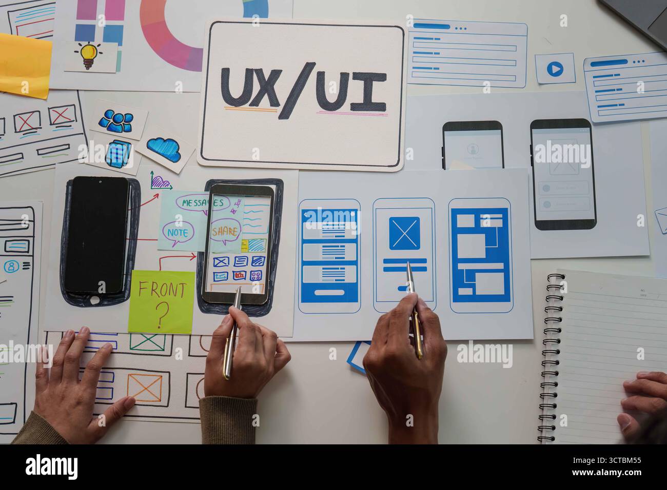 Collaborative UX UI Design. Team members working on mobile app wireframes and user interface. Stock Photo