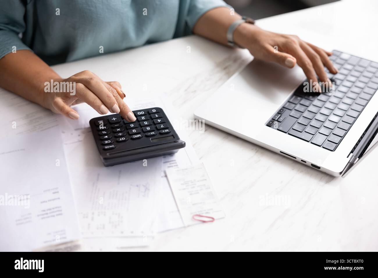 Accounting professional woman using laptop and calculator Stock Photo