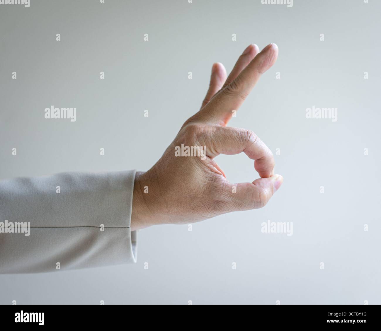 Businessman with ok sign, isolated on whtie background. Stock Photo