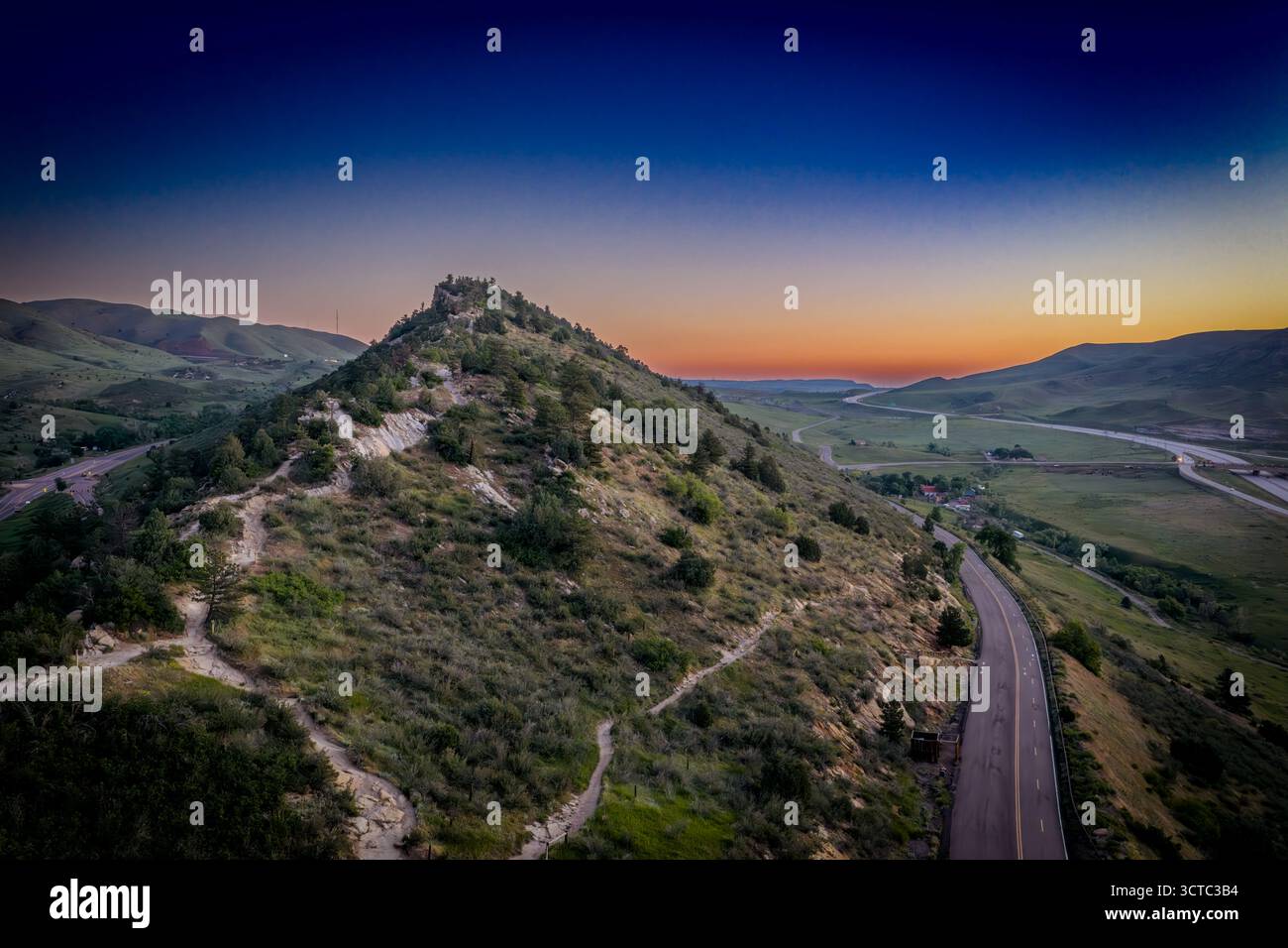 Aerial view of the rugged, scrub-covered slopes of Dinosaur Ridge meet ...