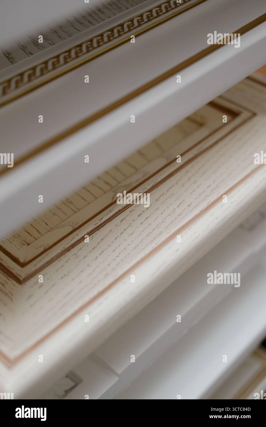 A stack of kitchen cabinet samples of different colors and textures on ...