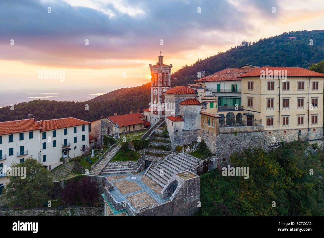 Aerial view of Santa Maria del Monte and the chapels of the sacred way during an autumn sunset. Sacro Monte di Varese, Varese, Lombardy, Italy. Stock Photo