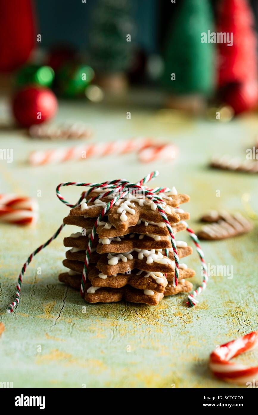 Festive stack of tree-shaped gingerbread cookies tied with string Stock Photo