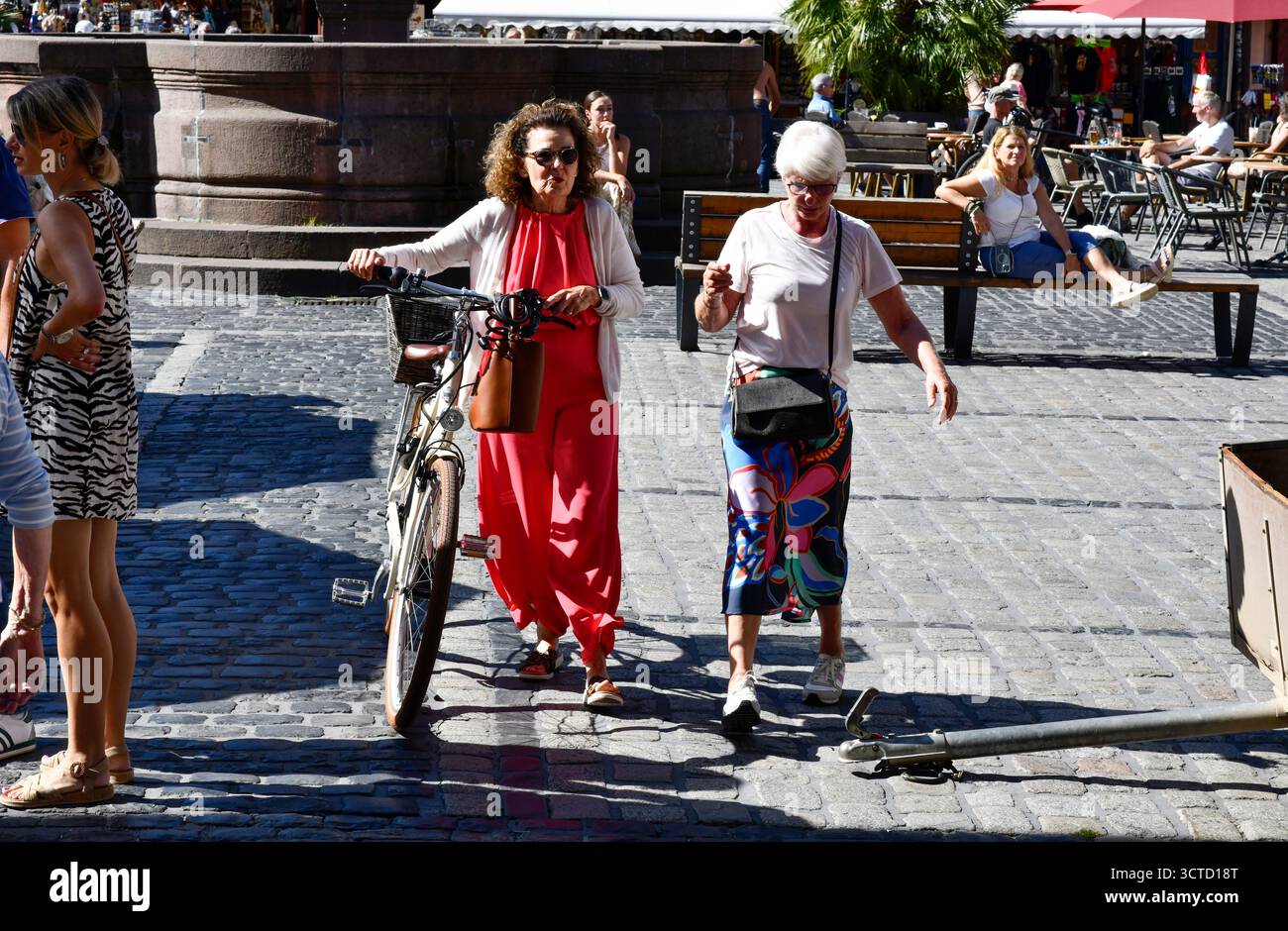 A female pedestrian manages to avoid a dangerous unmarked obstacle of a trailer towbar while walking in Heidelberg in southwestern Germany. Stock Photo