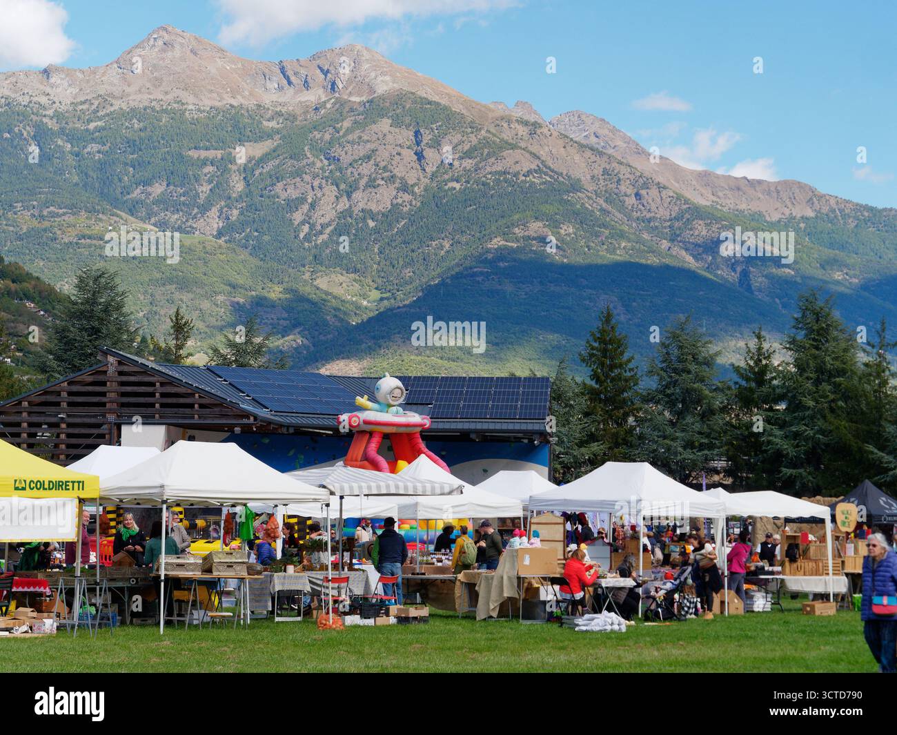 Market stalls during Apple festival in Gressan with mountains behind. Near Aosta city in Aosta Valley region, Italy. Oct 5th 2025 Stock Photo