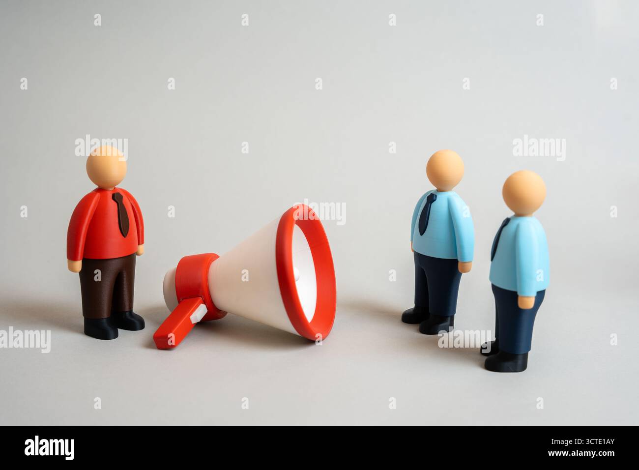 A businessman uses a megaphone to persuade other employees. Attracting investors and clients. Concept of leadership, influence, motivation, and corpor Stock Photo