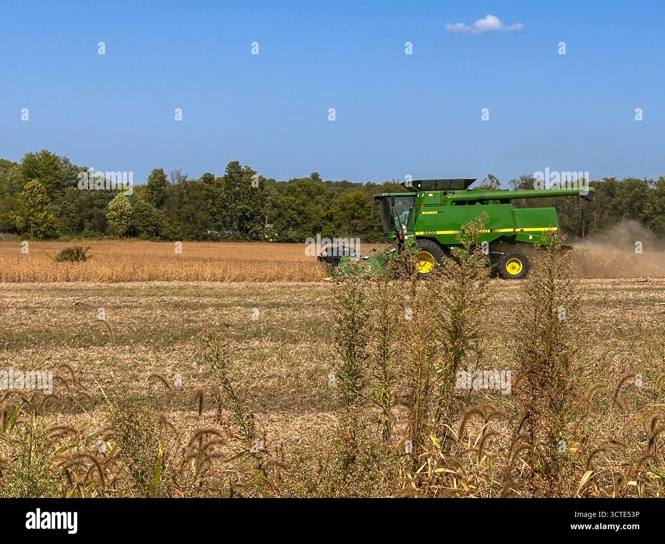 A farm field being harvested with John Deere equipment in the midwest. Westville, IN USA October 4, 2025 - Smartphone Captured Stock Image