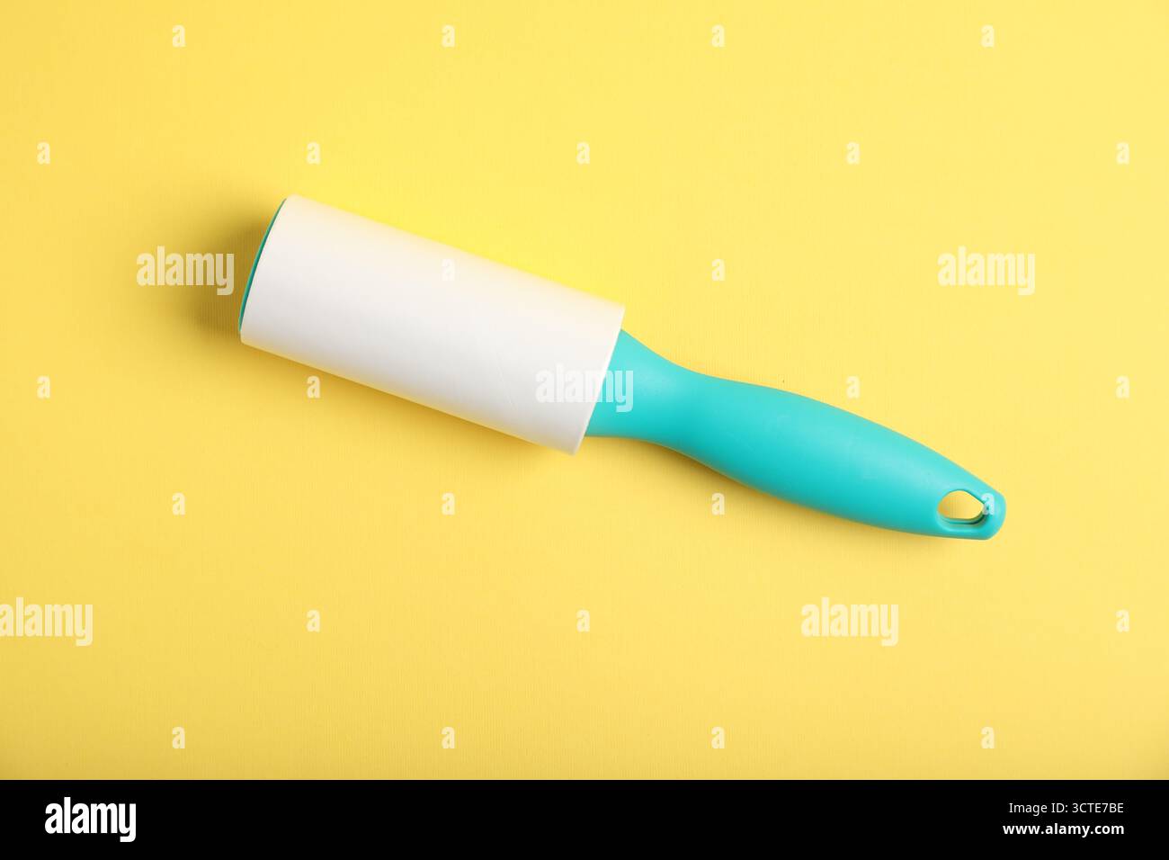 One lint roller on yellow background, top view Stock Photo