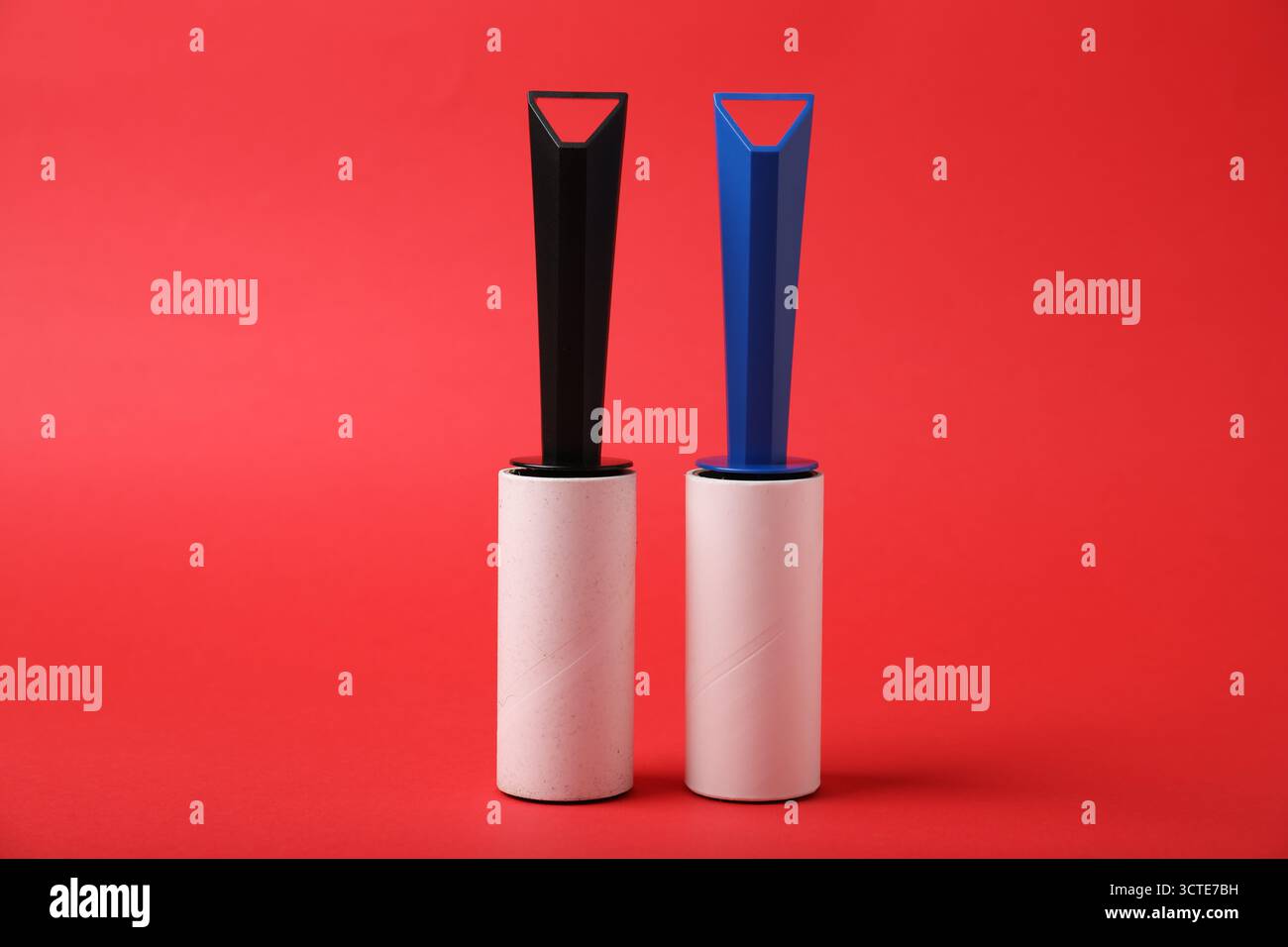 Two sticky lint rollers on red background Stock Photo