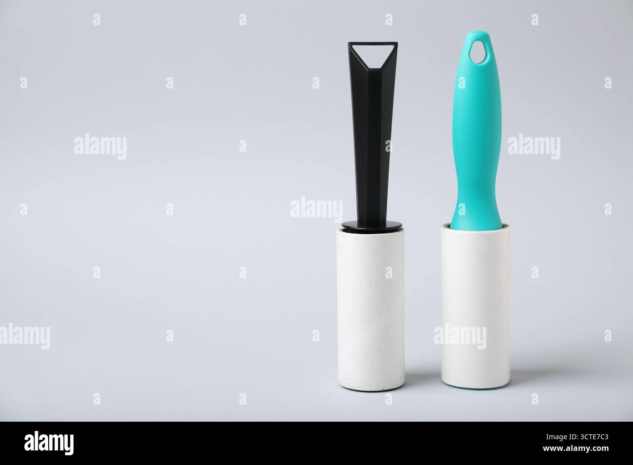 Two lint rollers on light grey background, space for text Stock Photo