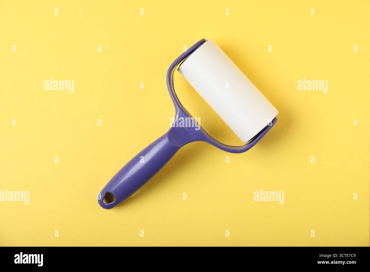One lint roller on yellow background, top view Stock Photo