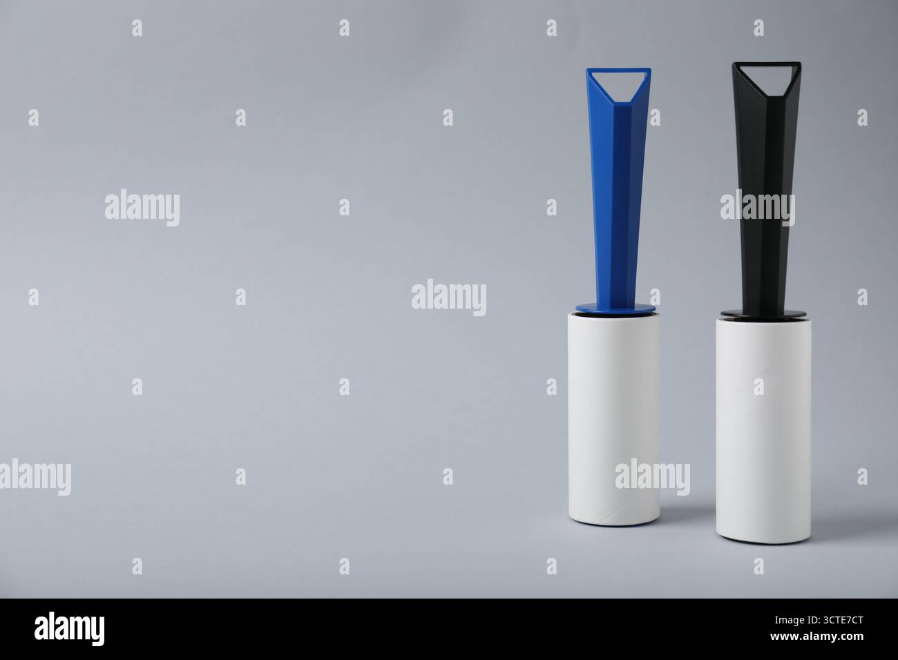 Two lint rollers on light grey background, space for text Stock Photo