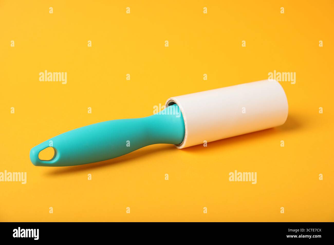 One lint roller on orange background, closeup Stock Photo