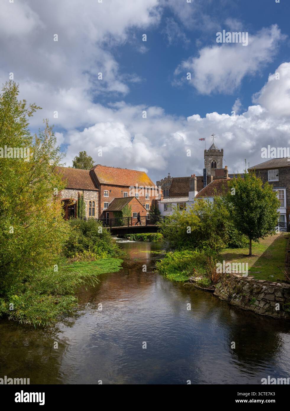 Salisbury, Wiltshire, UK:  The River Avon in central Salisbury seen from Fisherton Street with St Thomas's Church. A person walks accross the bridge. Stock Photo