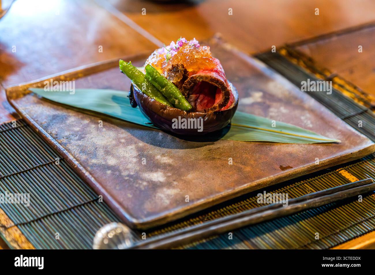 A course of beef rolls, okra and a glistening garnish shows the harmony of colour, shape and texture typical of kaiseki cuisine, at chef Atsuko Kato's Rakan restaurant, Izu Peninsula, Japan. Stock Photo