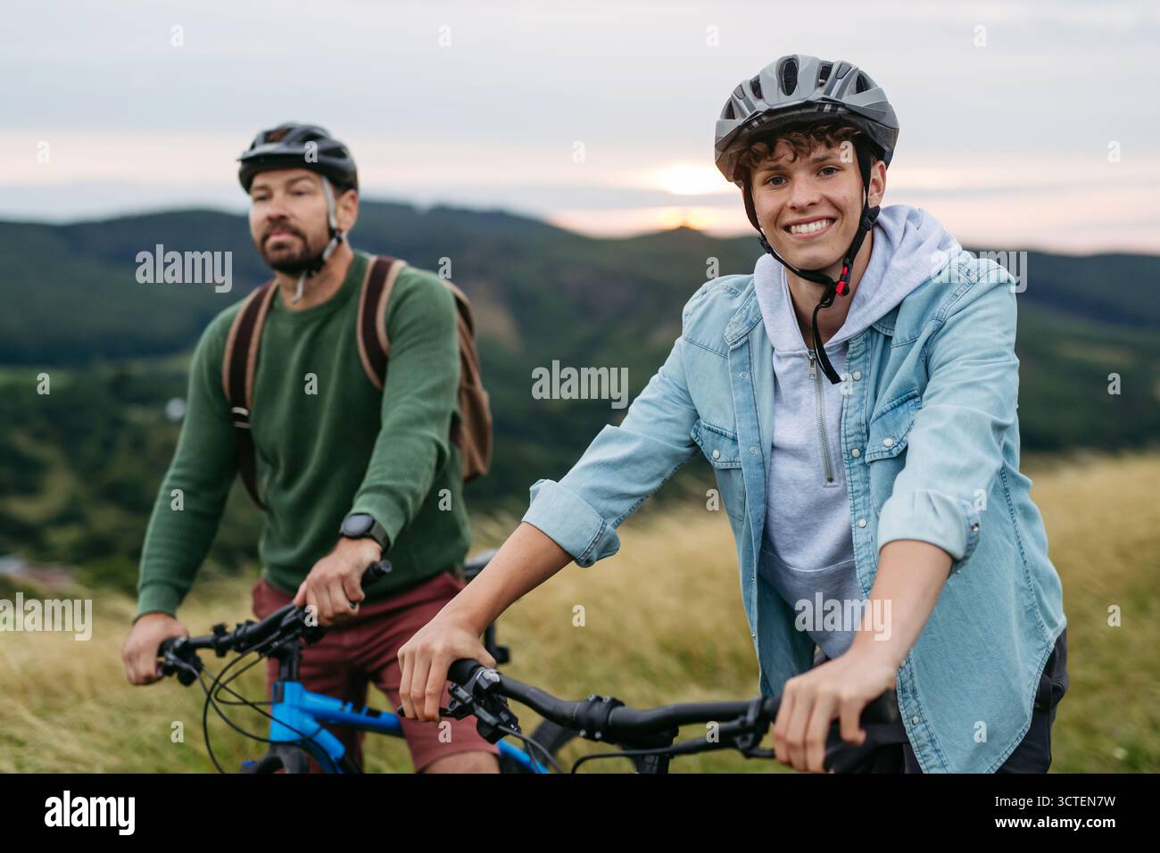 Father teen son in helmets hi-res stock photography and images - Alamy