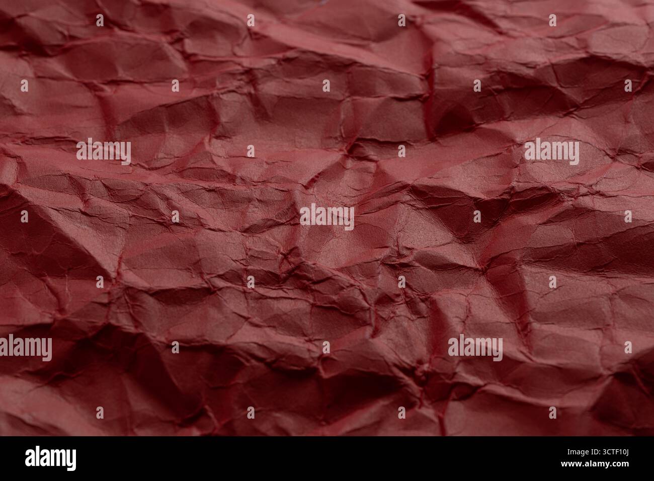 Crumpled red paper as background. Close up Stock Photo