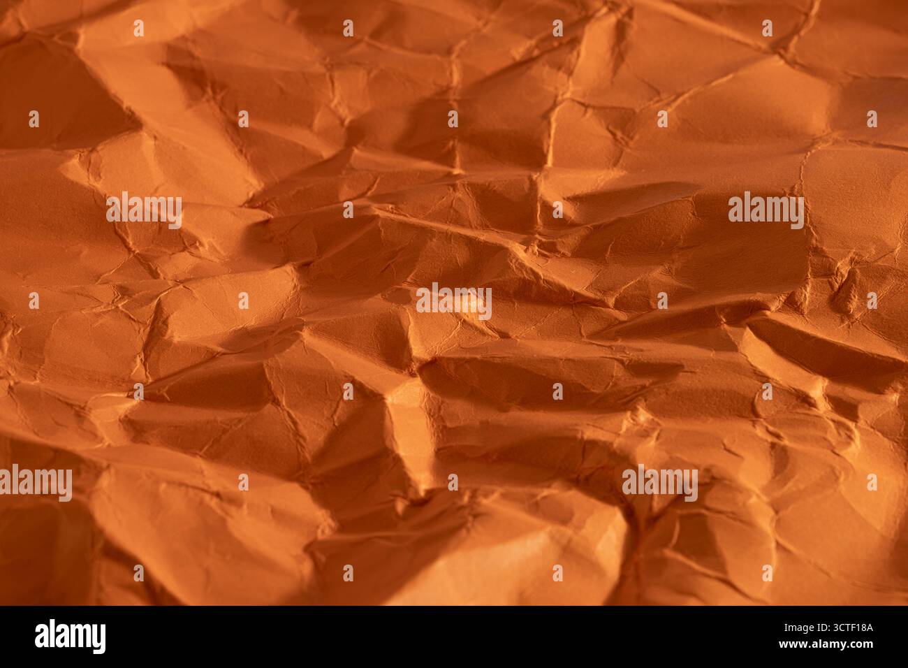 Orange crumpled paper as background, closeup Stock Photo