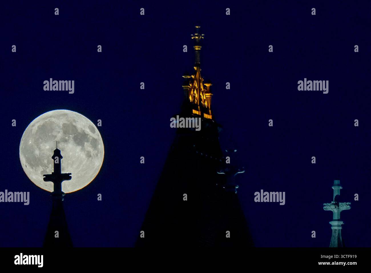 The Harvest Supermoon rises behind Tower Bridge, Monday, Oct. 6, 2025 ...