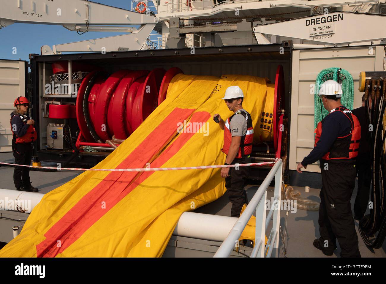 Crew members prepare to inflate a current buster six which is used as a ...